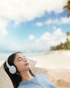young girl relaxing on the beach with headphone on